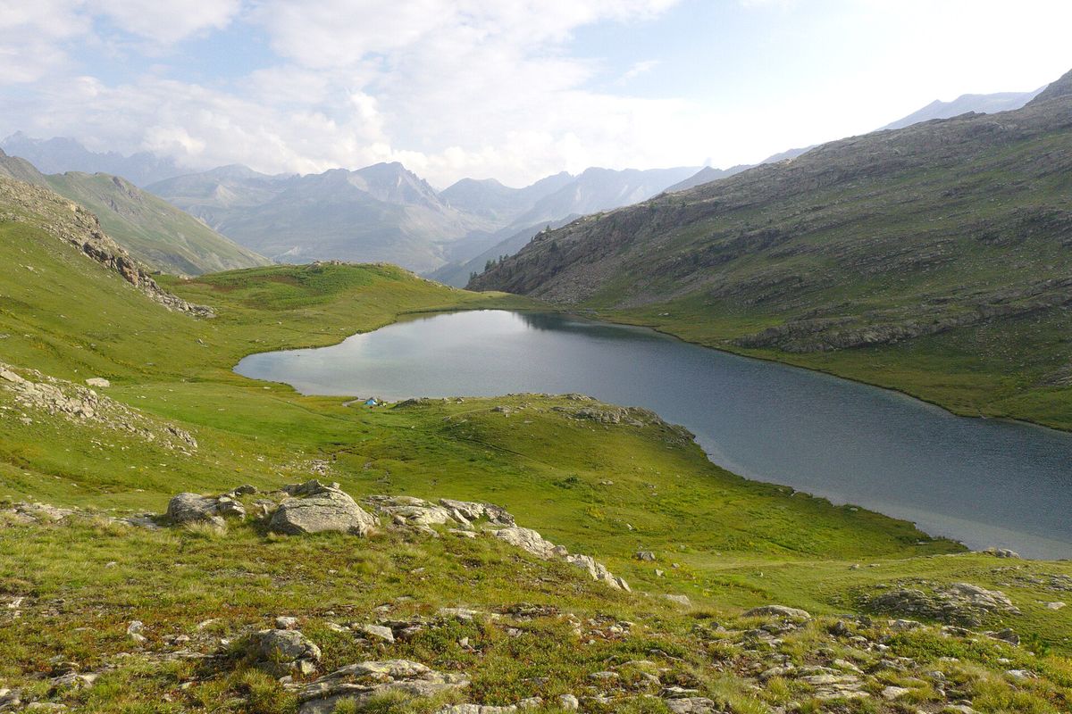 Le lac du Lauzanier dans son vallon herbeux, sous les crêtes